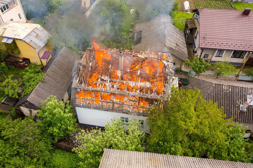 Aerial view of a house on fire with orange flames