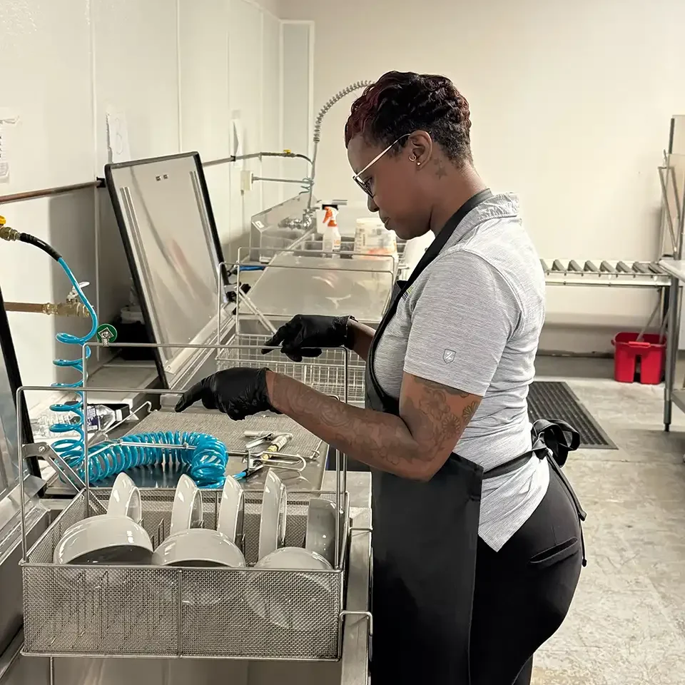 Contents Cleaning & Pack-Outs - Property Medics of Georgia A workers cleaning plates and bowls
