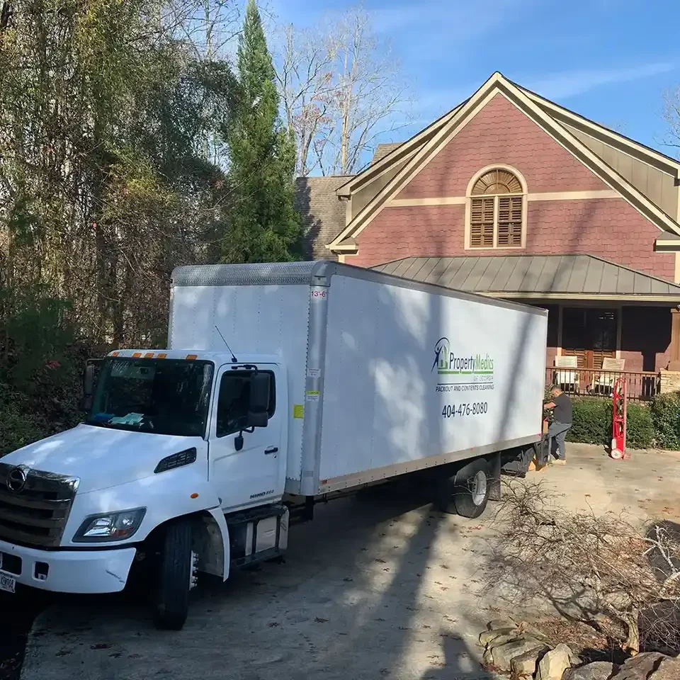 Contents Cleaning & Pack-Outs - Property Medics of Georgia A Property Medics truck in front of a house